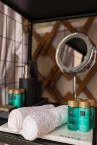 a bathroom counter with a towel and a mirror at Yurt with Hot Tub near Hartington, Peak District in Buxton