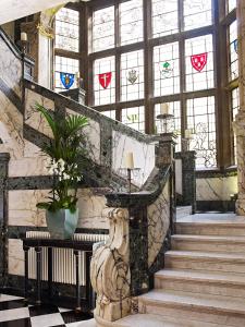 a staircase in a building with stained glass windows at The Scotsman Hotel in Edinburgh