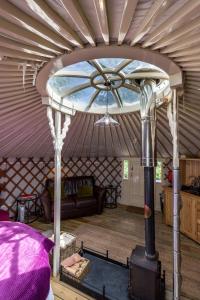 a room with a stove in a yurt at Yurt with Hot Tub near Hartington, Peak District in Buxton