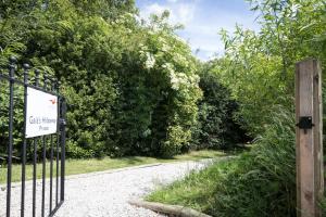a gate with a sign on the side of a road at Yurt with Hot Tub near Hartington, Peak District in Buxton