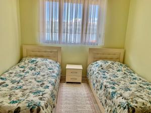 A bed or beds in a room at Syzo Apartments