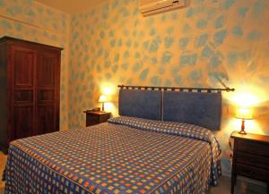 Postel nebo postele na pokoji v ubytování Hotel Residence I Briganti di Capalbio