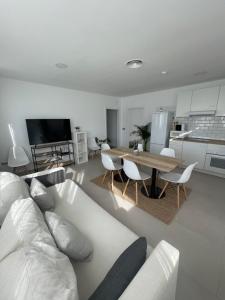 a living room with a white couch and a table at Villamartin Hotel GHB in Orihuela Costa