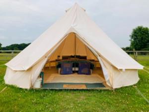 a large bell tent in a field of grass at Twinkle Bell 1 in Bartley