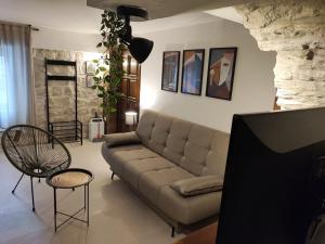 a living room with a couch and a tv at Carol Rooms in Trogir