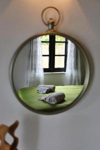 a mirror reflection of a bedroom with a window at Banyan Tree in Óbidos