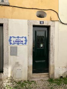 a building with a black door and a sign on it at Heart of Lisbon in Lisbon
