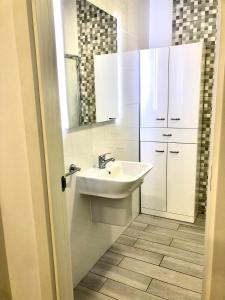 a white bathroom with a sink and a mirror at Apartamento Fuerteventura in Puerto del Rosario