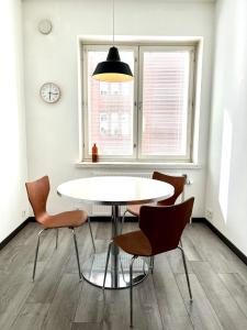 a dining room with a white table and chairs at Central Boutique in Helsinki