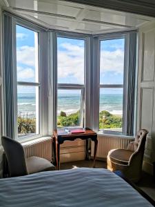 a bedroom with a view of the ocean from the window at Westcliff in Seascale