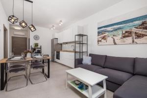 a living room with a couch and a table at Apartments Vila Belvedere in Rijeka