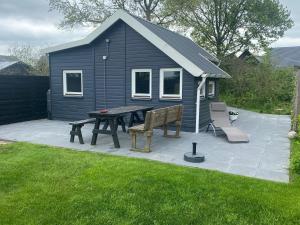 a picnic table and bench in front of a house at Blokhut Klein Meerzicht in Haren