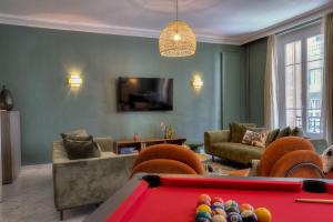 a living room with a pool table and a tv at Maison Lamartine - Nice in Nice