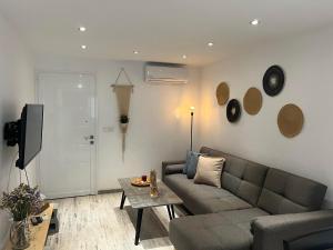 a living room with a couch and a table at Luxury Lavender in Larnaca