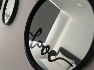 a mirror with the word peace written on it at Luxury Lavender in Larnaca