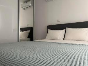 a bedroom with a large bed with a large mirror at Luxury Lavender in Larnaca