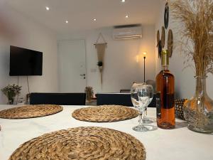 a table with a bottle of wine and a glass at Luxury Lavender in Larnaca