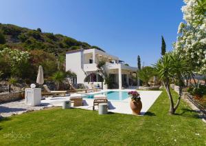 a villa with a swimming pool and a house at SHIGAYA Boutique Villa in Plaka
