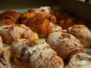 a bunch of pastries sitting on top of a table at 6 Small rooms in Naples