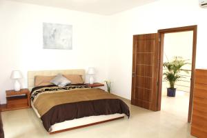 a bedroom with a bed and a sliding glass door at Beautiful 2 Floor Penthouse With Fabulous Views in Is-Swieqi