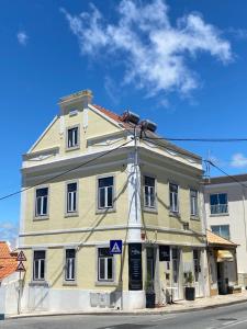 a large building on the corner of a street at Villa Sesimbra in Sesimbra