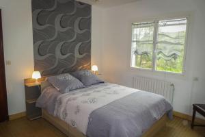 a bedroom with a bed and a window at Gite individuel au pays BASQUE à 1,5km de ST-Jean-Pied-de-port in Saint-Jean-Pied-de-Port