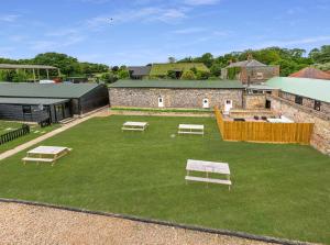an aerial view of a yard with picnic tables at The Flint Barn at Quex Park Estate in Birchington