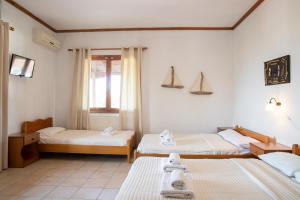 a room with two beds and a window at Gravanis Studios in Platamonas