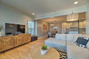 a living room with a couch and a flat screen tv at Grand Haven Condo Walk to Lake and Pool Access! in Grand Haven