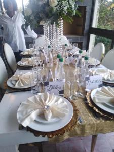 a table with plates and wine bottles on it at Stesh Margate Holiday House 12 Sleeper in Margate +21 photos