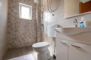 un baño con inodoro y lavabo en Apartments Glorija, en Neum 34 fotos más