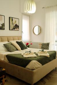 a bedroom with a large bed with towels on it at DANLÚ in Salerno