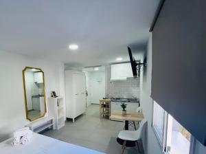a room with a bed and a desk and a mirror at Villamartin Hotel GHB in Orihuela Costa +170 photos