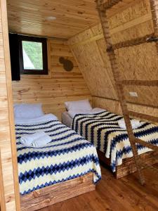two beds in a log cabin with a window at GLAMPING WOLF MOUNt in Margahovit +32 photos