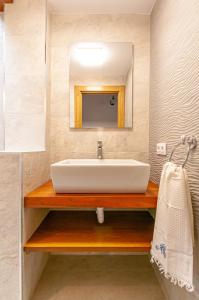 a bathroom with a sink and a mirror at La casita de susa en mazcuerras in Villanueva de la Peña