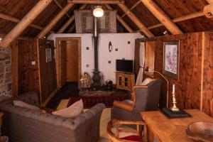 a living room with two couches and a table at Edinbane Self Catering - On the Croft at Edinbane in Edinbane