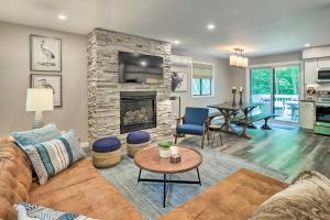 a living room with a couch and a fireplace at Cozy Gouldsboro Home with Fire Pit in Big Bass Lake! in Gouldsboro