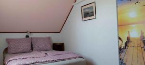 a bedroom with a bed and a painting on the wall at Holiday home in Balatonendred 33661 in Balatonendréd