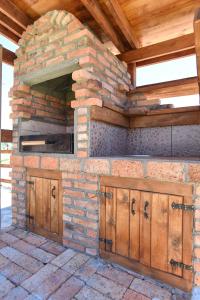 an outdoor kitchen with wooden cabinets and a brick wall at Big bear villas in Žabljak