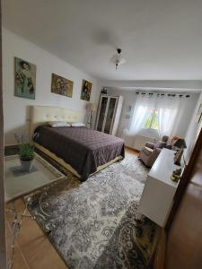 a bedroom with a bed and a living room at Aпартаменты на Ortenbach in Casas de Torrat