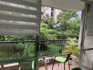 a balcony with a view of a garden at Mango Home in Ricaurte
