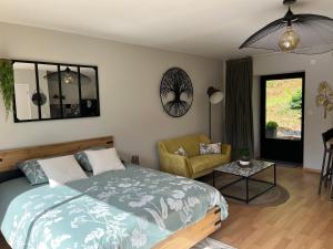 a bedroom with a bed and a living room at Studio d’étape, robinson Plaintel in Plaintel