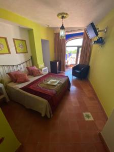 a bedroom with a bed and a television in it at Hotel Rural La Posada de las Cigüeñas in Jerez de los Caballeros