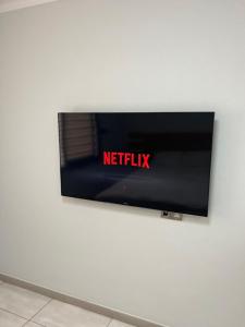 a television on a wall with the netflix sign on it at Nissi Breeze in Ayia Napa
