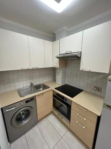 a kitchen with a washing machine and a sink at Nissi Breeze in Ayia Napa