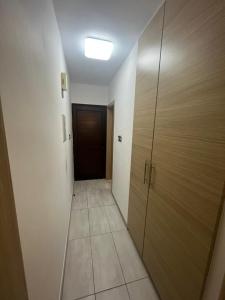 a hallway with a door and a room with a tile floor at Nissi Breeze in Ayia Napa