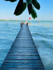 a wooden pier stretches out into the water at STUDIO VUE PORT ET MER in Valras-Plage