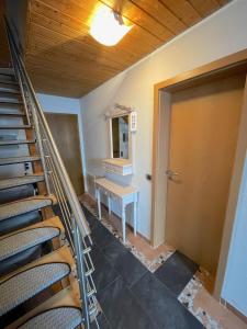 an empty room with a staircase and a table at Geräumiges Maisonette Apartment in Todtmoos