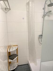 a bathroom with a shower with a shower curtain at Geräumiges Maisonette Apartment in Todtmoos