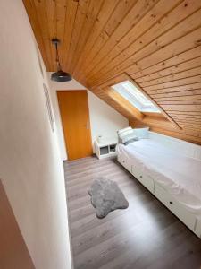 a bedroom with a bed and a wooden ceiling at Geräumiges Maisonette Apartment in Todtmoos